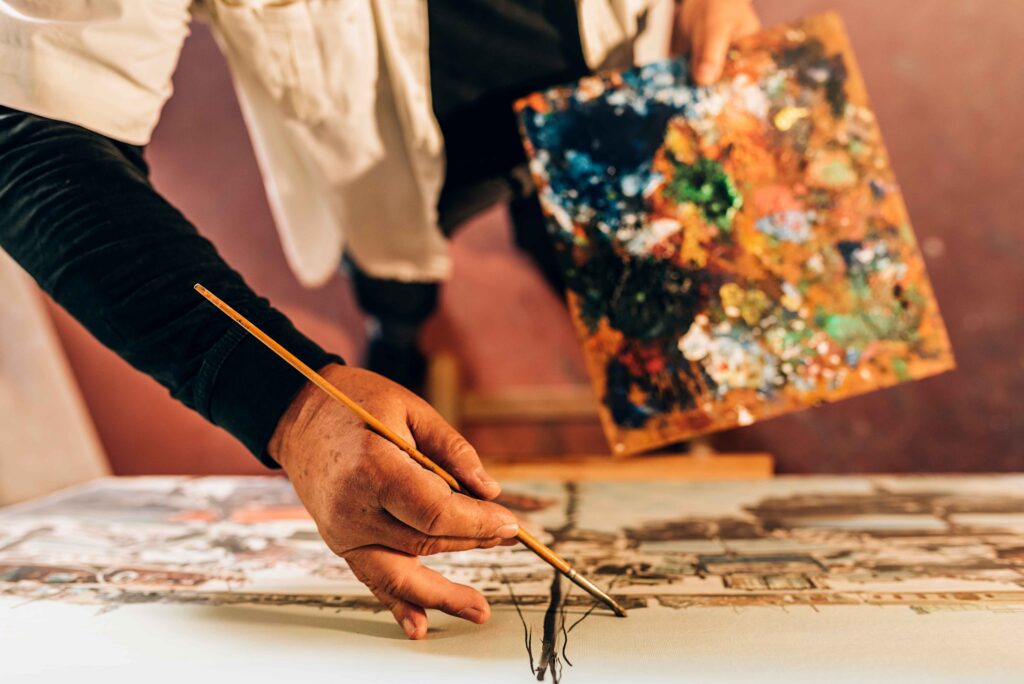 old-man-artist-painting-oils-in-his-studio