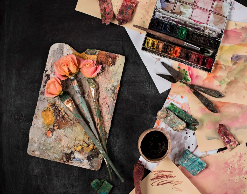 paint-brushes-and-tubes-of-oil-paints-on-wooden